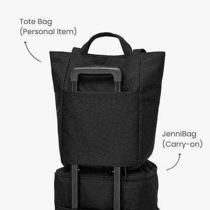 Black tote bag and carry-on bag stacked on a white background.